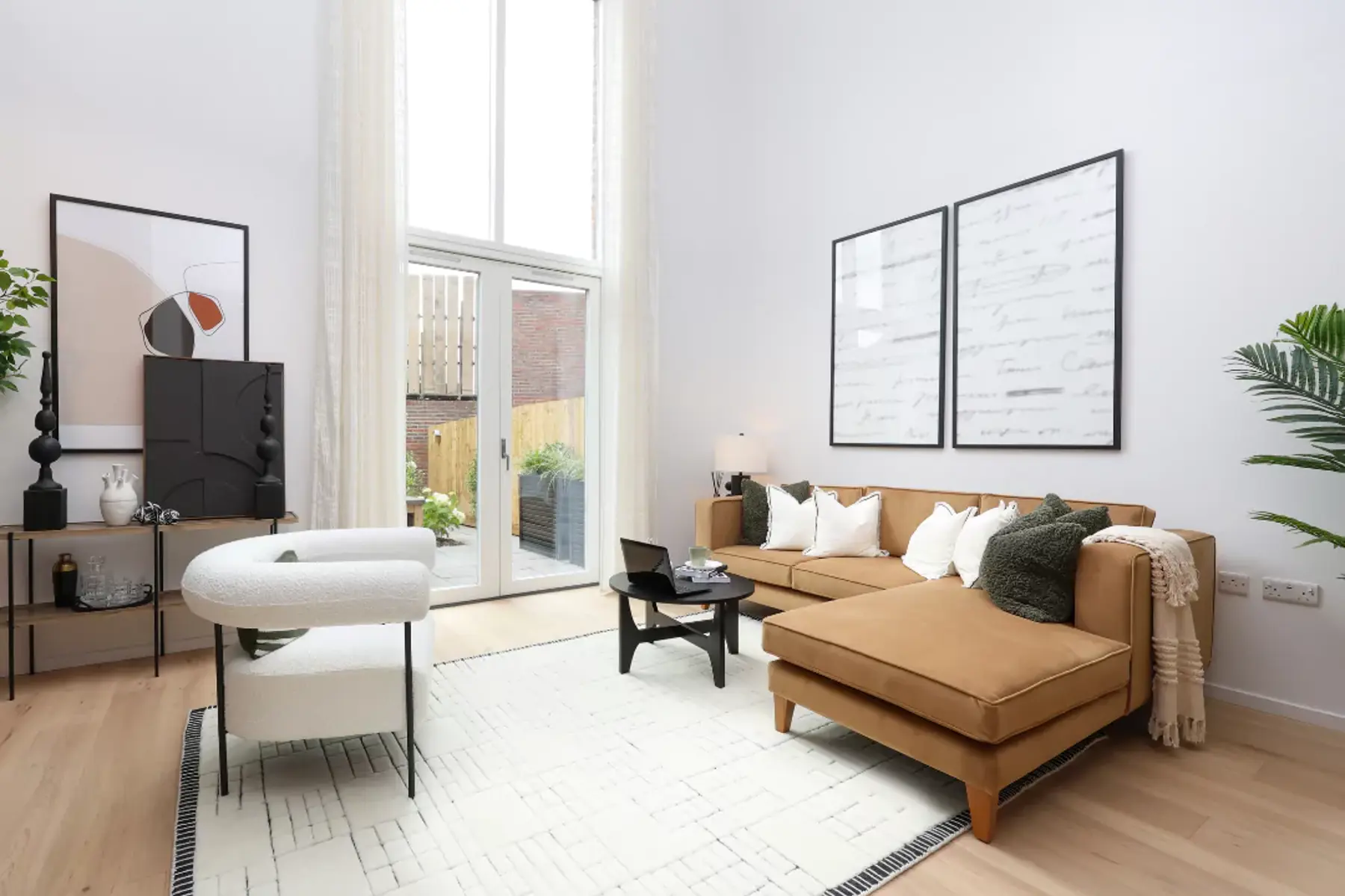 Styled double height living space with ample natural light flooding in from the patio doors.