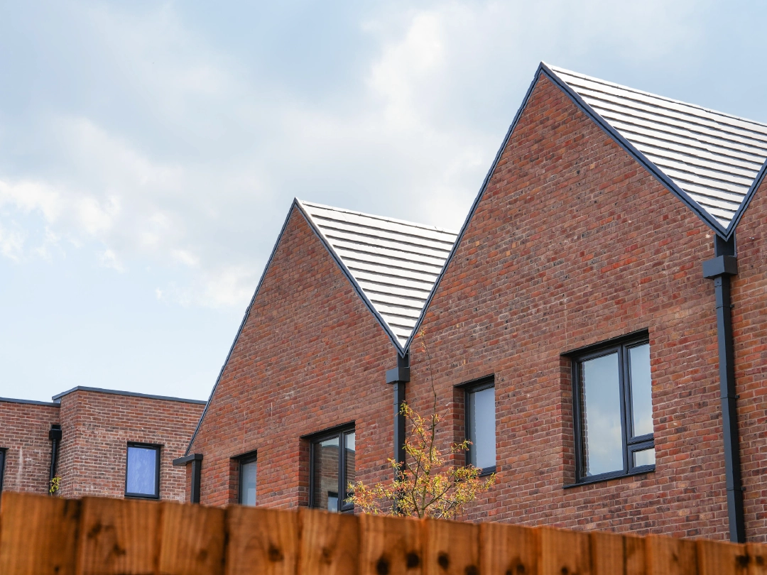 Modern brick terrace house, with A-frame roofline at Brabazon, Bristol.