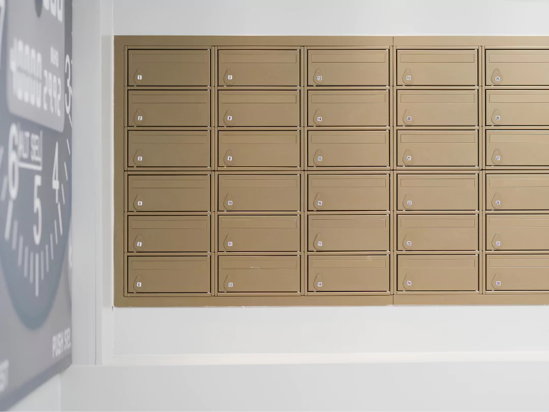 A close up of the apartment letterboxes which are gold in colour.