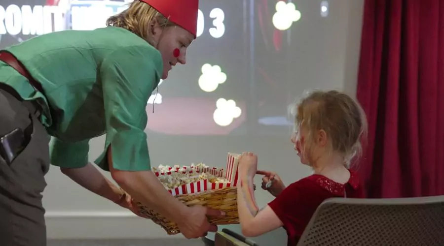Southern Brooks Community Development Worker handing out popcorn at the Wallace & Gromit film screening, in celebration of Gromit Unleashed 3 at Brabazon, Bristol. 