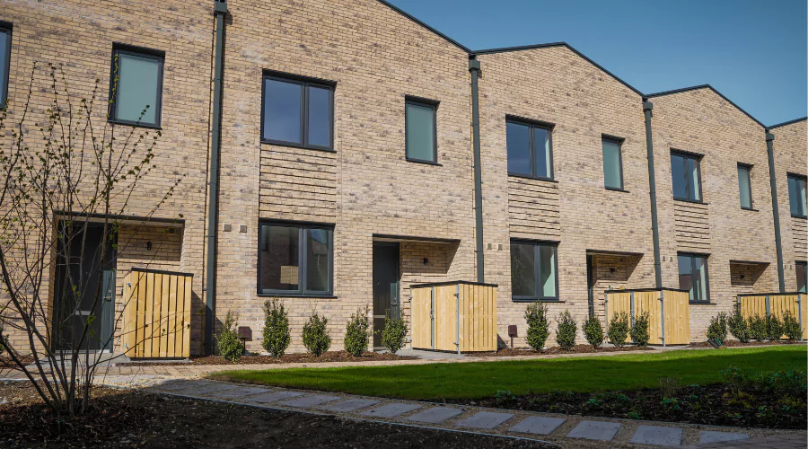 A row of new brick houses on a landscaped living garden street at Brabazon, Bristol.