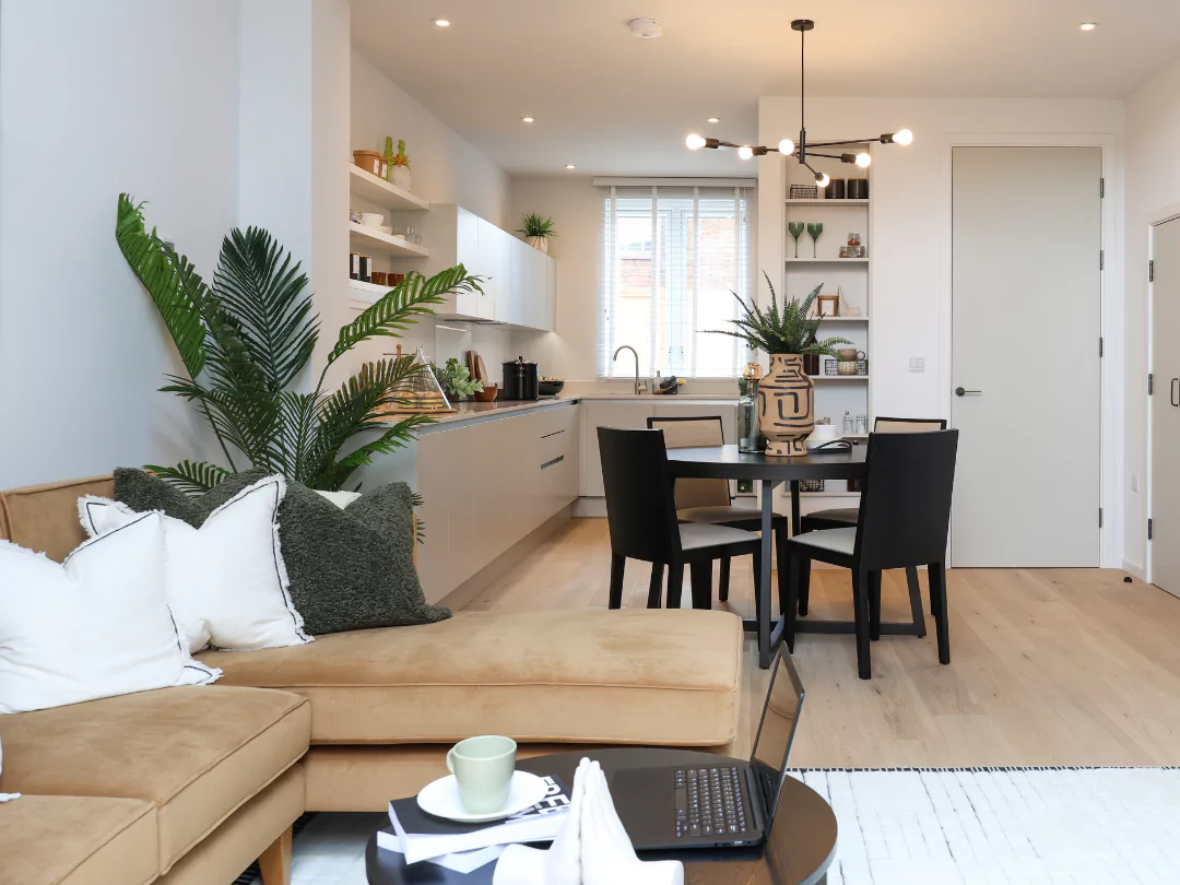 Open-plan living room and kitchen diner flooded with natural light leading in from double height patio doors.