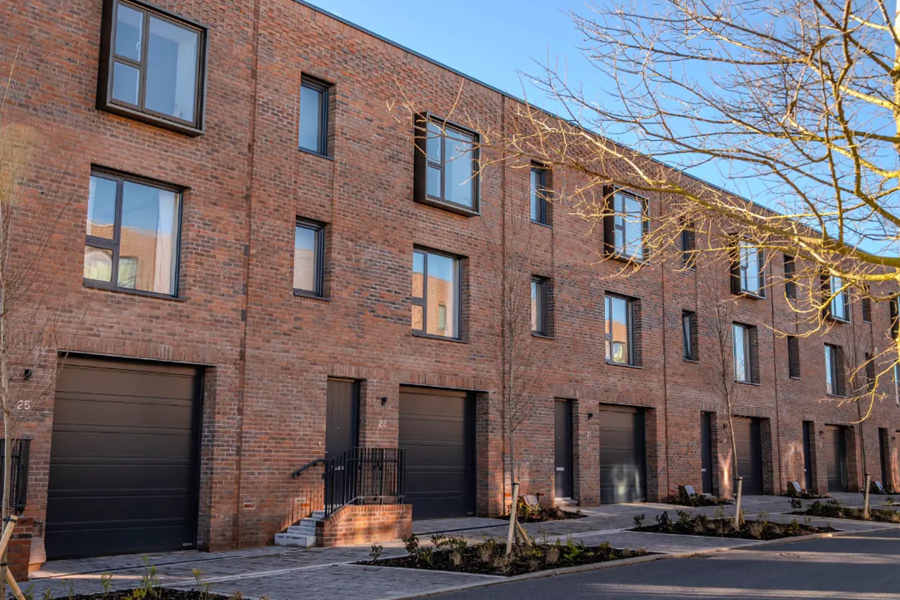 The front exterior of The Burney row of three-bedroom, red-brick terraced townhouses at Brabazon, Bristol.